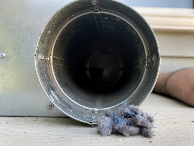 Smithfield Dryer Vent Cleaning technician using specialized equipment to clear severe dryer vent blockage in Smithfield
